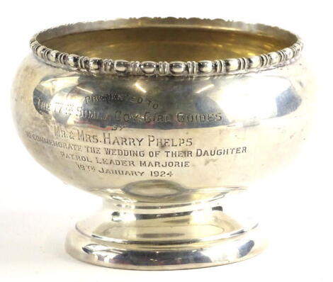 A George V silver presentation rose bowl, with a egg and dart border, engraved 'presented to the Fourth Simla Coy Girl Guides by Mr and Mrs Harry Phelps to commemorate the wedding of their daughter Patrol Leader Marjorie, 1924,' London 1922, 7½ oz, (AF).