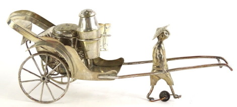 An eastern silver plated cruet, modelled in the form of a rickshaw, with spoked wheels, containing a salt, simulated basket cast mustard, and a pepper pot, unmarked.