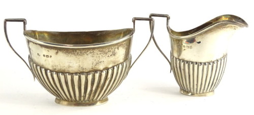 A George V silver part fluted two handled sugar bowl, and a matching milk jug, Birmingham 1910, 4½oz.