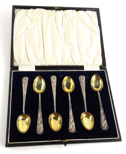 A set of six Chinese white metal teaspoons, each with a dragon cast to handle and a gilt bowl, in fitted black and leatherette case, 2.5oz all in.