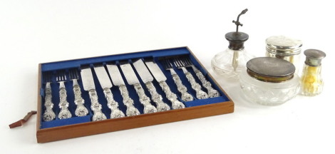 A collection of small silver dressing table items, to include cut glass with silver lid, cylindrical jar, perfume atomiser, and a part set of dessert knives and forks, etc., (AF).