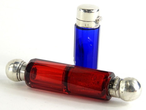 A continental Bohemian type double ended ruby tinted scent bottle, with silver coloured metal mounts to each end, and a blue glass scent bottle with silver mounts, marks indistinct, (2).