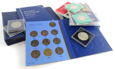 A quantity of coins, to include coin sets, a small album containing coins, etc.