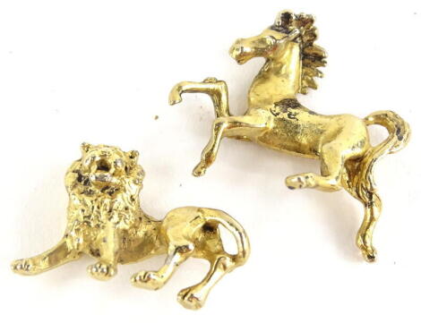 Two metal animal figures, comprising one of a horse, the other a lion, each with gold coloured finish. (2)