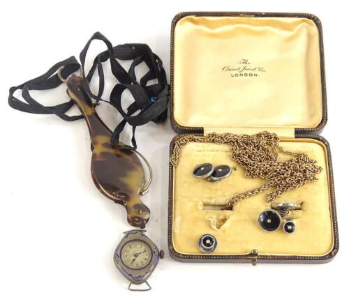 A small group of jewellery and trinkets, comprising a part set of gentleman's cufflinks and collar studs, a silver watch head, with rubbed enamel surround, marked Enila, a gold plated longuard chain and an imitation tortoiseshell and gold plated spectacle