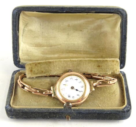 A mid 20thC 9ct gold wristwatch, with small circular white enamel dial, lacking hand, in 9ct gold casing on an expanding 9ct gold bracelet, boxed, 22.7g all in.