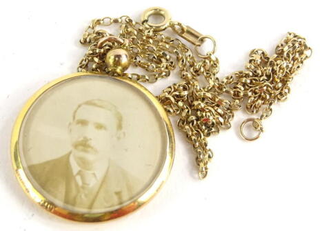 A double sided portrait pendant, in yellow metal and a fine link chain.