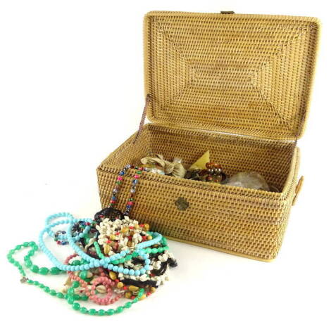 A quantity of costume jewellery and effects, to include lion belt buckle, beaded necklaces, Eastern style necklaces, various belt buckles, enamel design belt buckles, brooches, dress rings, etc. (in a wicker hamper).