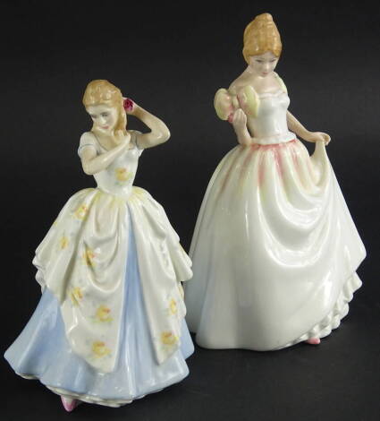 A Royal Doulton figure Laura, HN2960, 21cm high and another Gift of Love, HN3427, printed marks beneath (2).