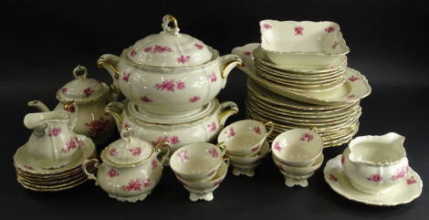 An Edelstein Bavarian part service, to include a pair of comports, 30cm wide, serving dishes, plates, teapot, milk jug, two handled sugar bowl, cups, saucers, etc., decorated with flowers with gilt highlights, printed marks beneath (a quantity).