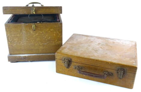 An unusual Norwegian self-enacting cooking apparatus, in stained pine case with a zinc lined metal container to the interior and a suitcase containing accessories, etc. for the set.