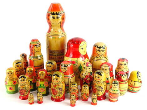 A collection of mid to late 20thC Russian dolls, various sizes and decoration, the largest 33cm high.