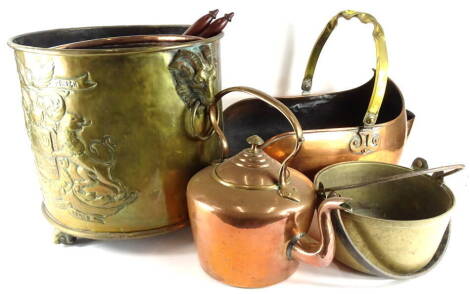 A collection of metal wares, to include a two handled brass coal bucket, embossed with an elaborate crest, two preserve pans, a shaped copper and brass coal scuttle, copper kettle, brass and turned wood coat hangers, etc.