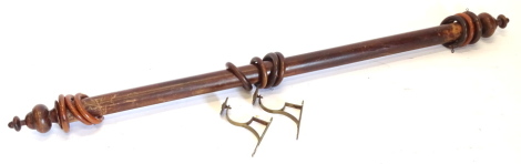 A Victorian mahogany curtain pole, with various rings and turned finials, 153cm wide.