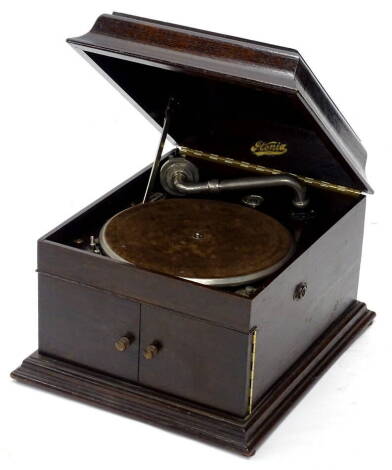 An Itonia vintage wind up gramophone, in oak case, with chrome plated mounts, on a moulded plinth, (AF), 42cm wide.