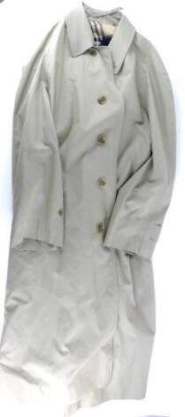 A gent's Burberry London mackintosh, in off cream, with typical tartan lining.