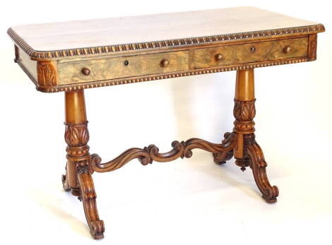 A William IV rosewood library table, the rectangular top with a gadrooned edge, above two frieze drawers, on turned and lappet carved end supports, with scroll shaped stretcher, and shaped legs, 74cm high, 115cm wide, 62cm deep.