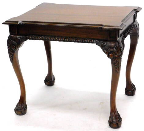 An eastern hardwood mahogany low table in George III style, the rectangular top with a moulded edge and reentrant corners, above a panelled frieze on scroll carved cabriole legs with ball and claw feet, 57cm high, the top 66cm x 53cm.