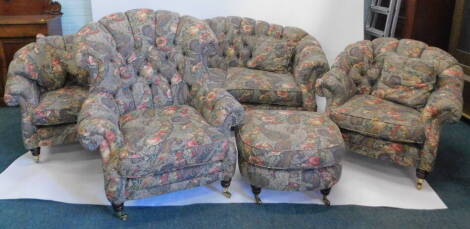 A high quality shell back five piece lounge suite, comprising two seater settee, large armchair, two small armchairs, a 'D' end foot stool, and matching curtains, in floral pattern material, the settee 157cm wide.