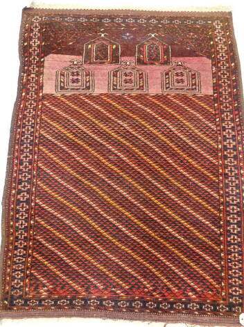 A Persian type prayer rug, with a geometric design, arch to one end and decorated with five further arch devices, one wide and various narrow borders, 81cm x 116cm.