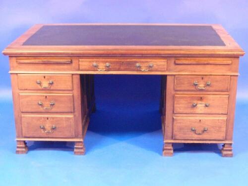 An early 20thC mahogany desk with leather inset top