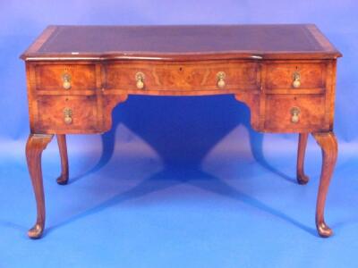 A Queen Anne style walnut writing or dressing table with leather inset