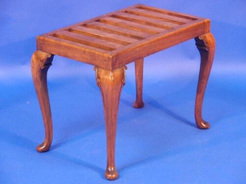 A Queen Anne style suitcase stand with slatted top on carved cabriole legs