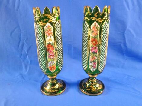 A pair of Bohemian green and white overlay vases