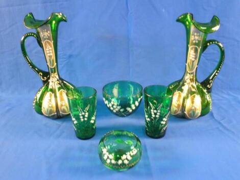 A pair of Victorian green glass ewers