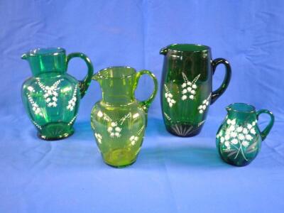 Four Victorian green glass jugs