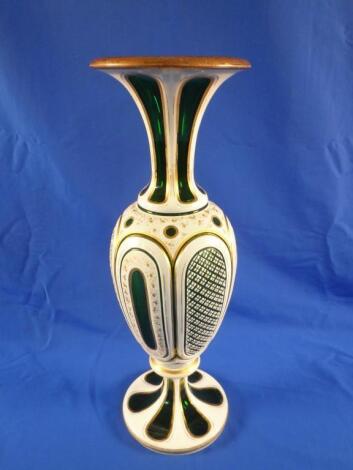 A late 19thC Bohemian green glass vase with white overlay