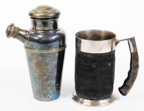 A tankard, of cylindrical form, with metal mounts, horn handle and textured body, marked SPC, 15cm high and an Art Deco silver plated cocktail shaker. (2)