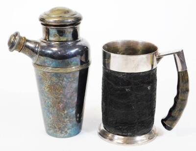 A tankard, of cylindrical form, with metal mounts, horn handle and textured body, marked SPC, 15cm high and an Art Deco silver plated cocktail shaker. (2)