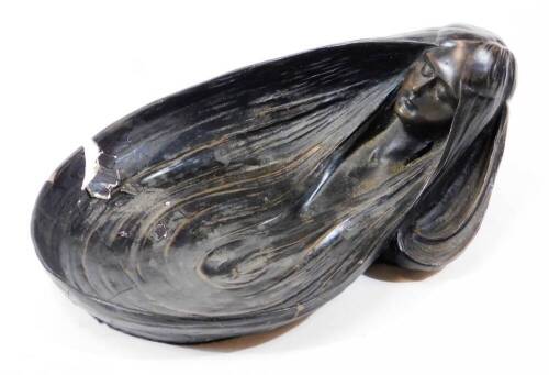 A 20thC Jugendstil pottery Art Nouveau pin dish, in a bronze finish with a figural handle formed as a maiden, her hair as the bowl, bearing marks for Gustav Gurschner, 22cm wide. (AF)