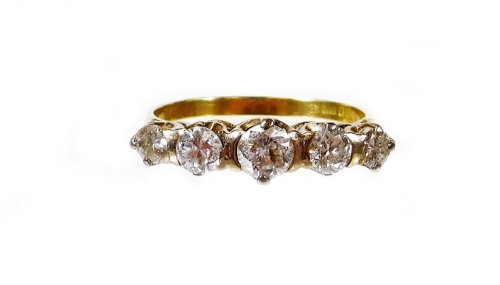 An 18ct gold five stone diamond ring, set with five graduated round brilliant cut diamonds, in a platinum setting, central stone approx 0.29cts, flanked by two smaller stones each approx 0.18cts, flanked by two smaller stones each approx 0.13cts, totallin