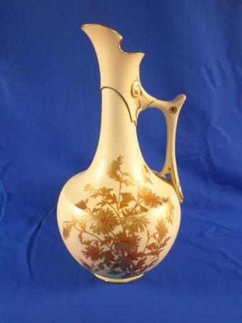 A Royal Worcester ewer decorated with chrysanthemum in gilt on a blush ivory ground