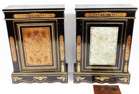 A pair of ebonised cabinets, each of rectangular form, with gilt mounts, decorative classical panelled doors and raised spandrels on serpentine bases, raised with further gilt metal flowers and scrolls, with further brass type stencilling, 114cm high, 93