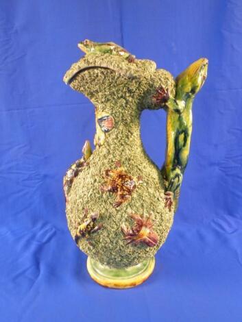 A late 19thC Portuguese Palissy type jug and cover applied with toads