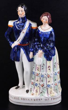 A 19thC Staffordshire flatback polychrome figure of Princess Royal & Frk. of Prussia, depicting Victoria and Albert in standing pose, 42cm high.