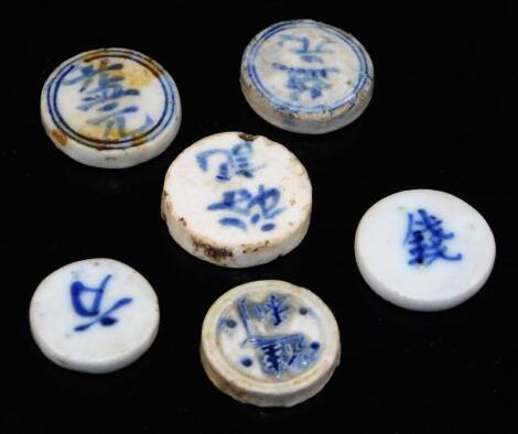 Six various Chinese blue and white porcelain gaming markers, 2cm max.