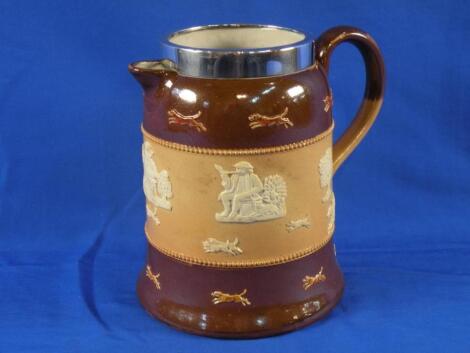 A Royal Doulton stoneware hot water jug decorated in relief with rural scenes etc.