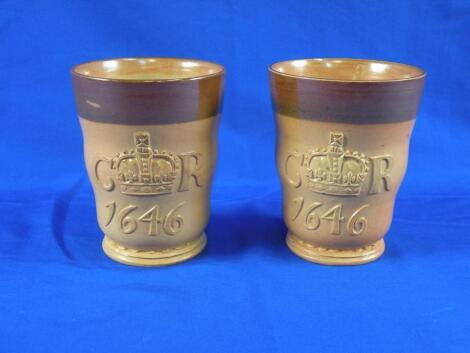 A pair of Doulton Lambeth stoneware beakers