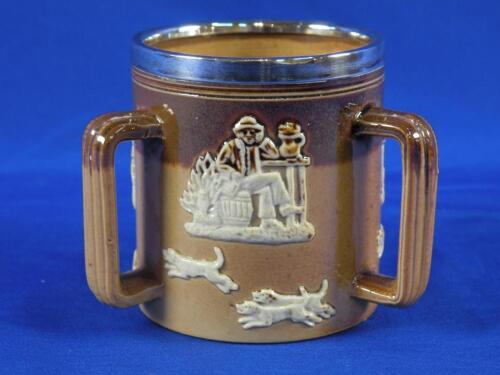 A Doulton Lambeth tyg decorated in relief with rural scenes with a silver collar