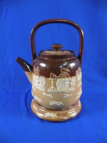 A Doulton Lambeth stoneware tea kettle and lid decorated in relief with rural scenes etc