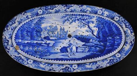 A 19thC blue and white Brameld pearlware pottery meat platter and drainer, of oval form set with courting couple, he holding fish rod before stream, trees and building, marked beneath, 70cm wide. (AF)