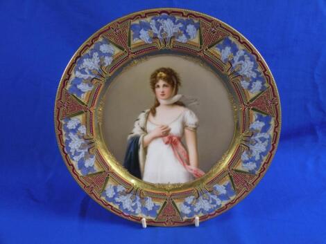 A Vienna porcelain plate decorated with a lady wearing a white dress