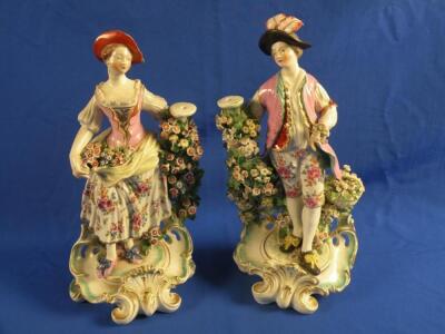 A pair of late 18thC Derby bocage figures in the form of a lady and gentleman