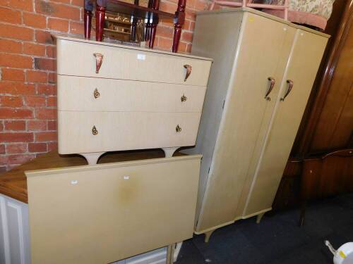 A mid 20thC limed oak bedroom suite, comprising double wardrobe, 177.5cm high, 95cm wide, 51cm deep, a three drawer dressing chest, 131cm high, 47.5cm deep, and a headboard.