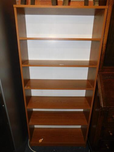 A teak effect bookcase of six shelves, 161.5cm high, 75cm wide.