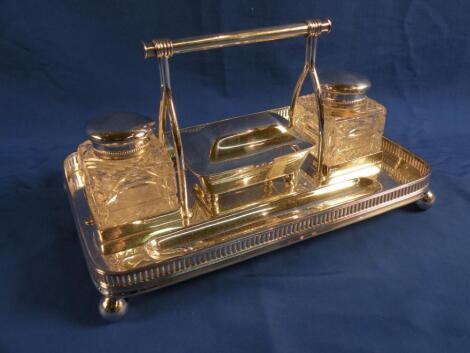 A silver plated ink stand with carrying handle